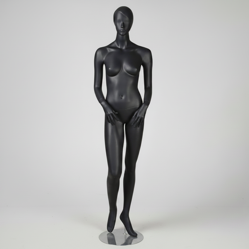 1400 damemannken. Grå, matt med hode, ansikt og skulpturert hår. H 178 cm. Hender foran